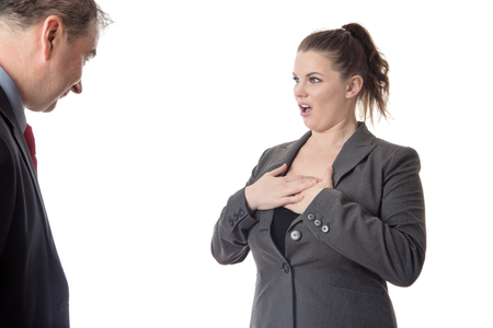 business man looking at a colleague breasts and not her faceの写真素材