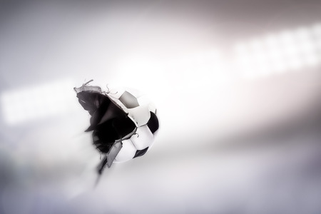 traditional football flying through the air after being hit so hard it explodesの写真素材