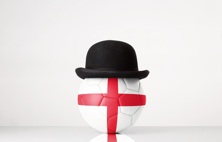 still life image of football wearing a bowler hat with England flag superimposed on footballの写真素材