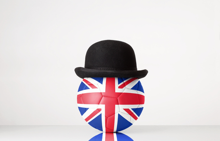 still life image of football wearing a bowler hat with United Kingdom flag superimposed on footballの写真素材