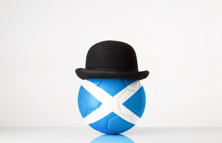 still life image of football wearing a bowler hat with Scotland flag superimposed on footballの写真素材
