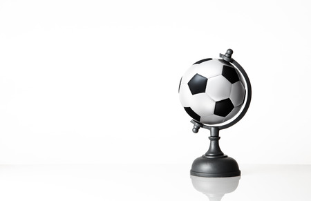 still life image of football world globe on whiteの写真素材