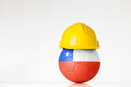 still life image of football wearing a hard hat with the Chile flag  superimposed on the footballの写真素材