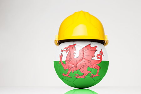 Football wearing a hard hat with the Wales flag superimposed on the footballの写真素材