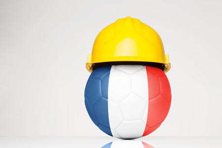 Football wearing a hard hat with the France flag superimposed on the footballの写真素材