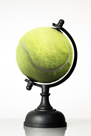still life image of tennis ball world globe on whiteの写真素材