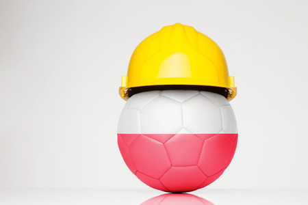 Football wearing a hard hat with the Poland flag superimposed on the footballの写真素材