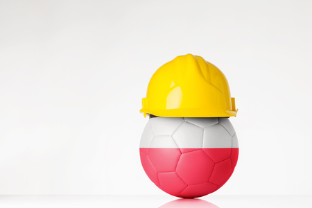 still life image of football wearing a hard hat with the Poland flag  superimposed on the footballの写真素材