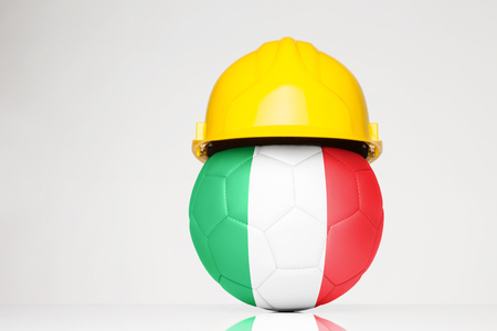 Football wearing a hard hat with the Italy flag superimposed on the footballの写真素材