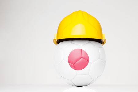 Football wearing a hard hat with the Japan flag superimposed on the footballの写真素材