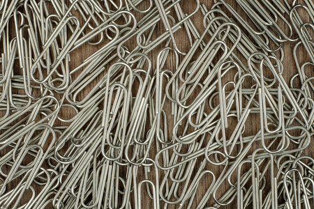 many paper clips on wooden backgroundの写真素材