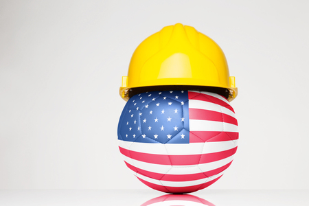 Football wearing a hard hat with the USA flag superimposed on the footballの写真素材