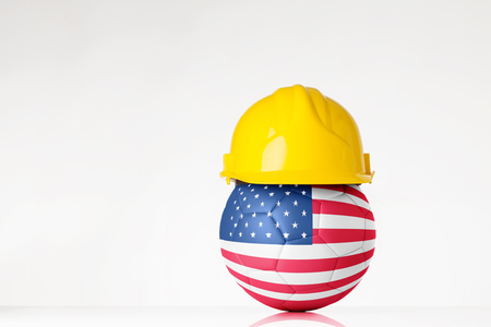 still life image of football wearing a hard hat with the USA flag  superimposed on the footballの写真素材