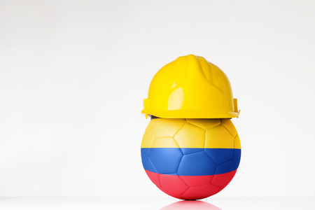 still life image of football wearing a hard hat with the Colombia flag  superimposed on the footballの写真素材