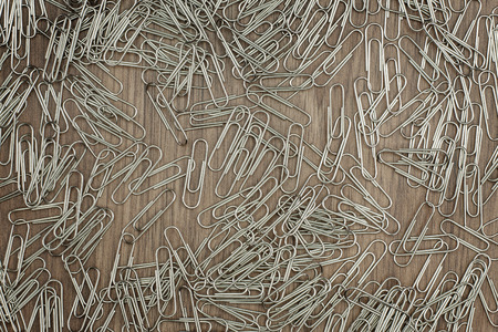 many paper clips on wooden backgroundの写真素材