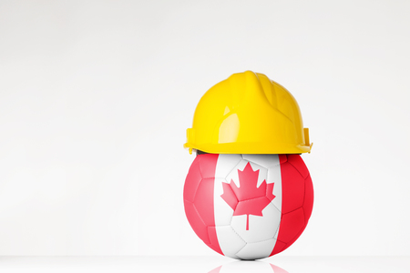 still life image of football wearing a hard hat with the Canada flag  superimposed on the footballの写真素材