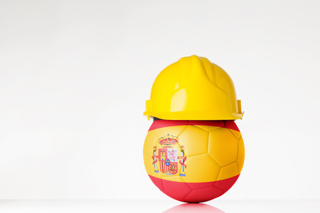 still life image of football wearing a hard hat with the Spain flag  superimposed on the footballの写真素材