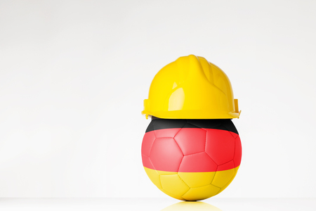 still life image of football wearing a hard hat with the Germany flag  superimposed on the footballの写真素材