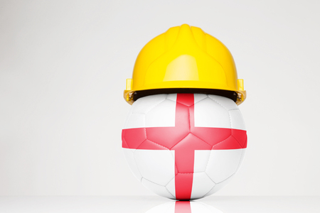 Football wearing a hard hat with the England flag superimposed on the footballの写真素材