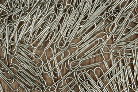 many paper clips on wooden backgroundの写真素材