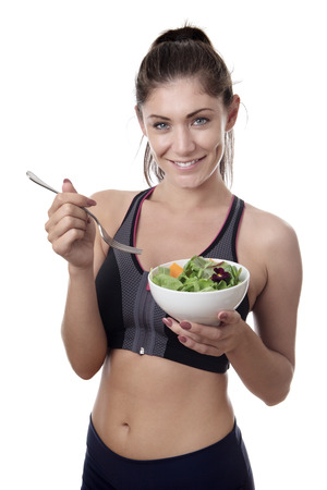 happy fitness woman holding a bowl of saladの写真素材
