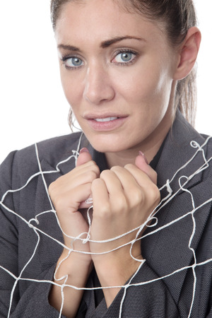 business woman caught up in a netの写真素材