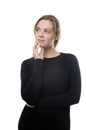 fitness woman all in black in deep thought looking up to the side of herの写真素材