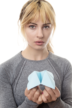 blonde haired woman woman wearing gym clothes using a origami choice makerの写真素材