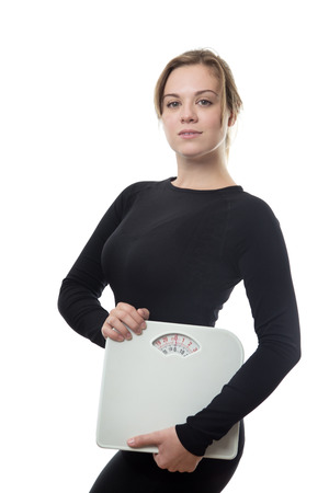 fitness woman wearing black holding scalesの写真素材