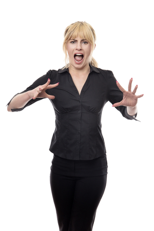 blonde haired business woman standing looking around scaredの写真素材