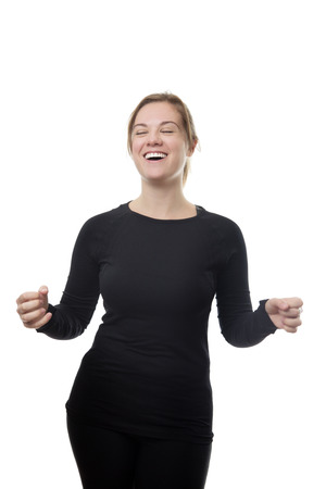 happy excited fitness woman all in black with her hands up in the airの写真素材