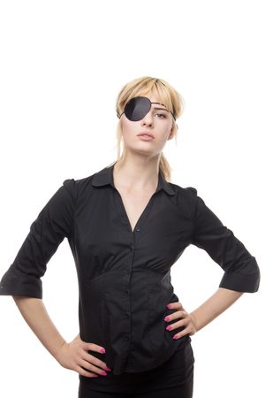 blonde haired business woman in a shirt wearing a eye patchの写真素材
