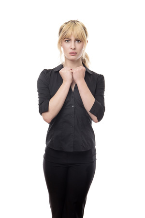 blonde haired business woman standing looking around scaredの写真素材