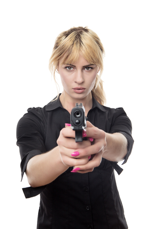 blonde haired business woman pointing a gun at the cameraの写真素材