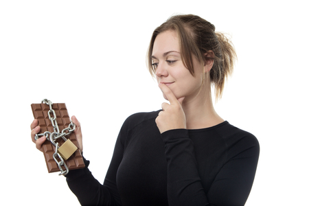 young fitness woman has found her chocolate bar locked upの写真素材