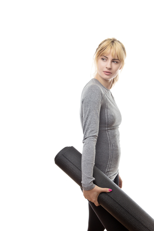 woman holding a gym mat ready for a work outの写真素材