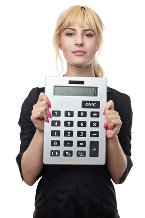 blonde haired business woman holding up a large calculatorの写真素材