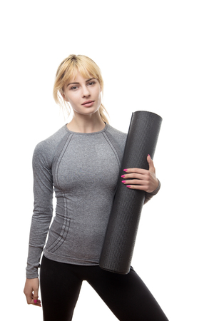 woman holding a gym mat ready for a work outの写真素材