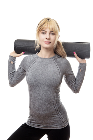 woman holding a gym mat ready for a work outの写真素材