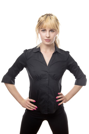 standing blonde haired business woman with her hands on hipsの写真素材