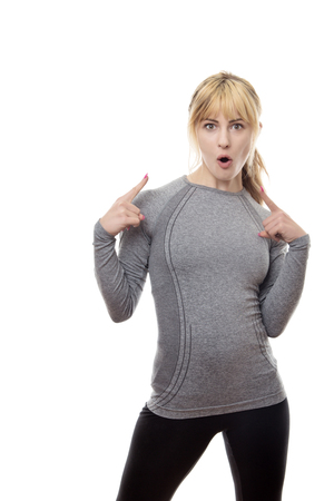 blonde fitness woman pointing at her self with a look of surprise on her faceの写真素材