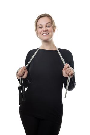 happy fitness woman all in black holding a skipping ropeの写真素材