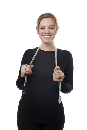 happy fitness woman all in black holding a skipping ropeの写真素材