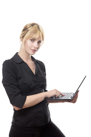 blonde haired woman stand working on a computerの写真素材