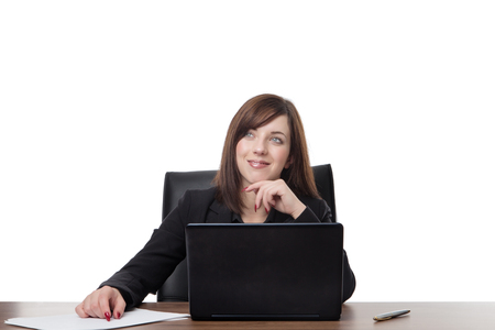 business woman siting at her desk at work daydreaming at workの写真素材