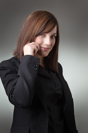 portrait of young business woman talking on the phome shot in the studioの写真素材