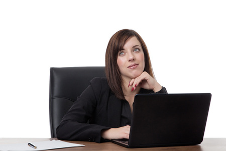 business woman siting at her desk at work daydreaming at workの写真素材