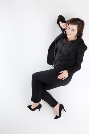 business woman on the phone lying on the ground shot from aboveの写真素材