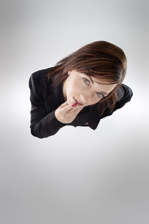 business woman shot from above looking up at cameraの写真素材