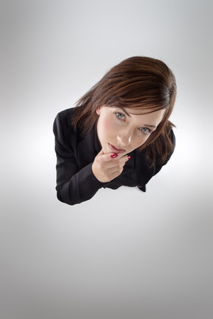 business woman shot from above looking up at cameraの写真素材